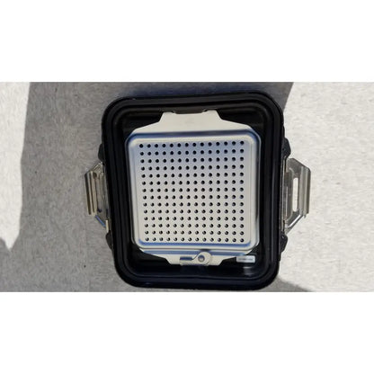 Silver perforated grill insert inside black rugged genesis sterilization container half lid with metallic latches