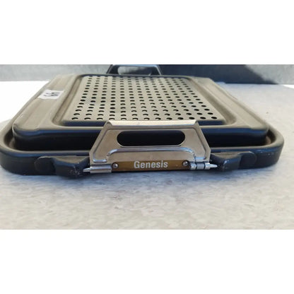 Black and silver Genesis sterilization container half lid with a perforated cooking surface for efficient sterilization