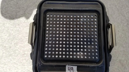 Black plastic genesis sterilization container half lid with perforated surface and metallic side handles