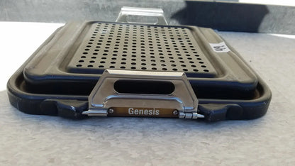 Black plastic genesis sterilization container half lid with perforated metal insert and silver handle bearing genesis brand name