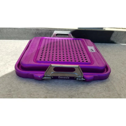 Purple plastic genesis sterilization container half lid with perforated surface and metallic clasp for sterile storage