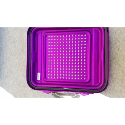 Purple plastic genesis sterilization container half lid with black rim and perforated surface for sterilization use