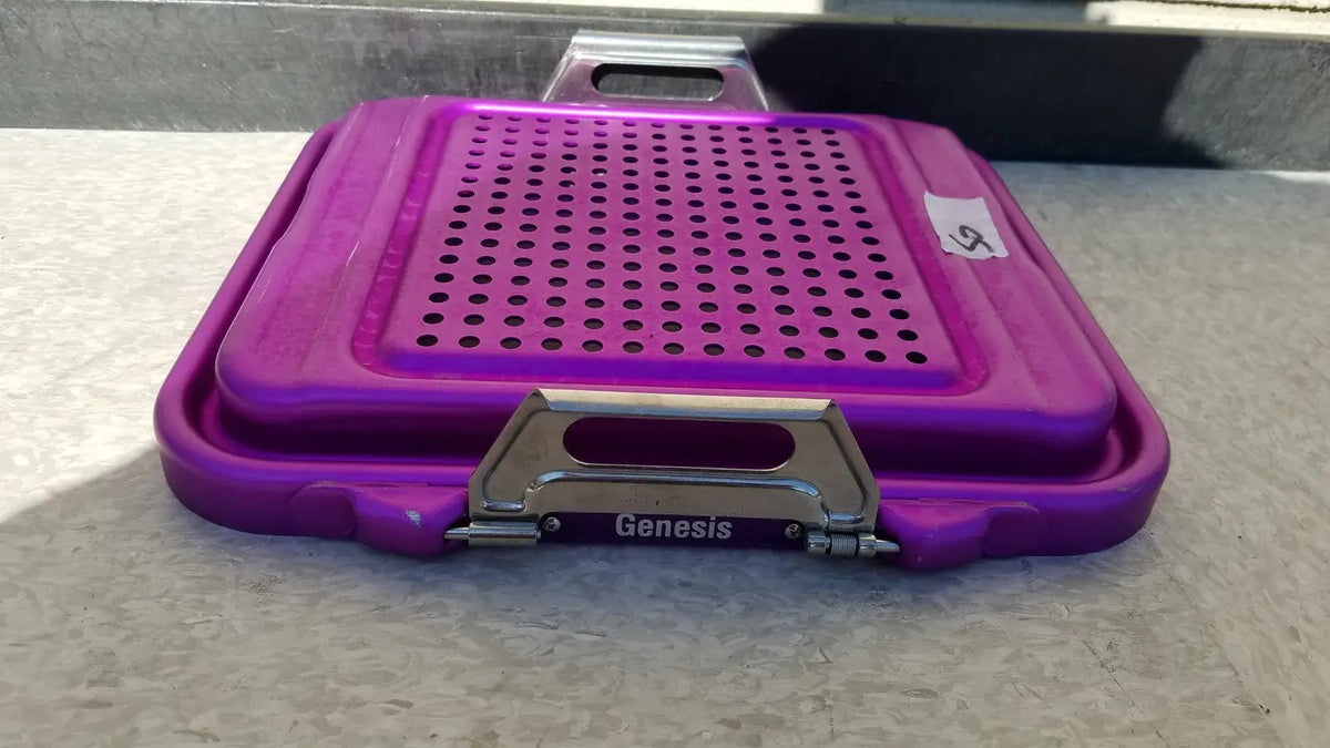 Purple plastic genesis sterilization container half lid with perforated surface and metallic clasp for sterile storage