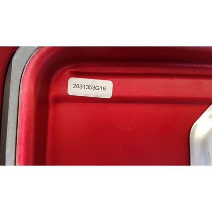Red plastic genesis sterilization container half lid with white label showing serial number 2831353g16