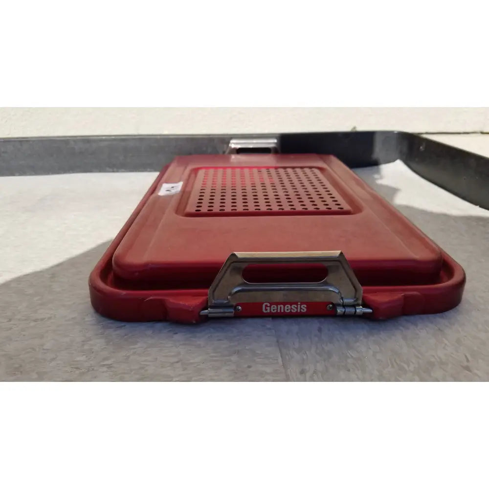 Red plastic genesis sterilization container half lid with perforated design and metal handle for secure closure