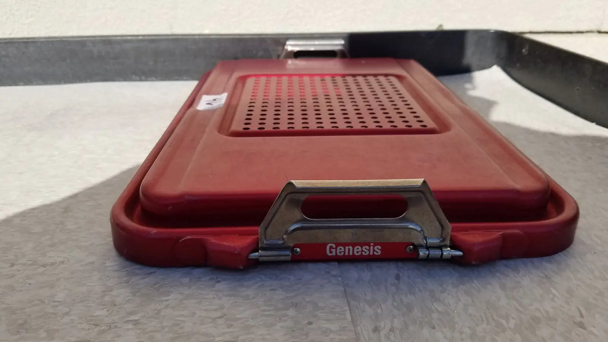 Red plastic genesis sterilization container half lid with perforated design and metal handle for secure closure