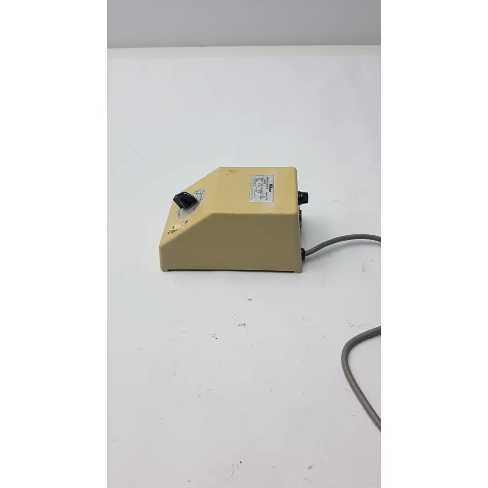 Beige plastic laboratory mixer with black rotary knob and power cord for genuine Nikon transformer xn made in Japan