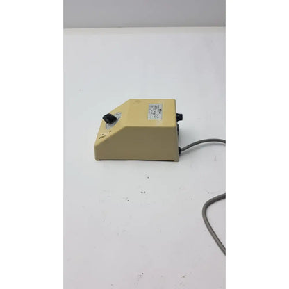 Beige plastic laboratory mixer with black rotary knob and power cord for genuine Nikon transformer xn made in Japan