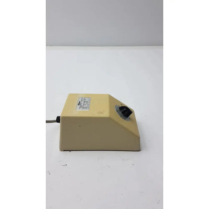 Beige plastic lab mixer with black rotary knob and label on genuine nikon transformer xn made in japan