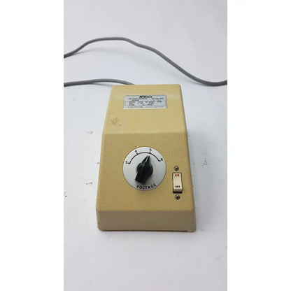 Beige genuine Nikon transformer xn made in Japan with black voltage dial and red-on-white toggle switch