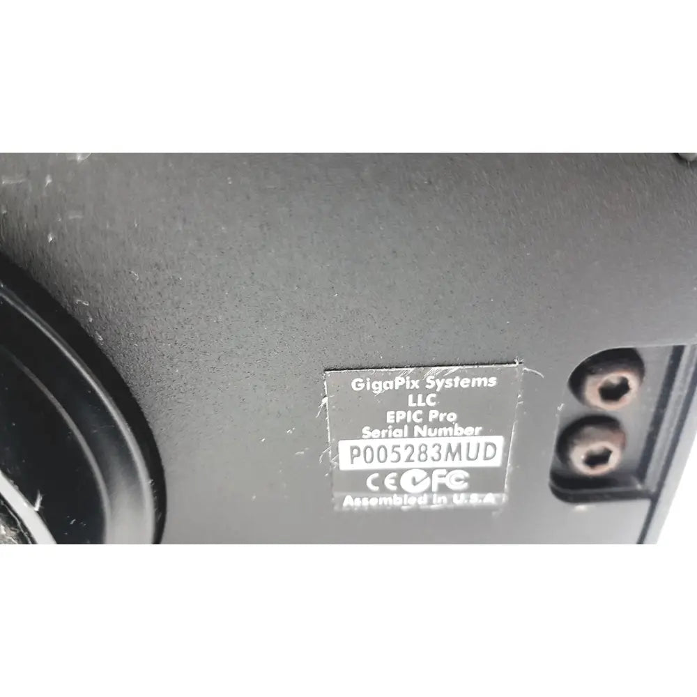 Black plastic label with white text on the back of a gigapan epic pro robotic motorized panohead camera mount