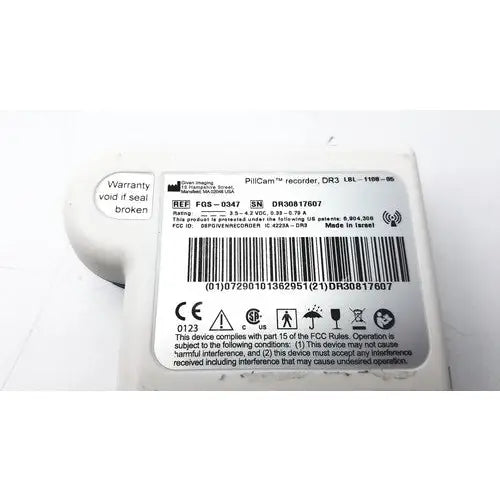 White plastic pillcam recorder body with black text and barcode label of fgs-0347 pillcam recorder back side reuse medical