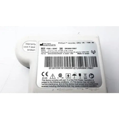 White plastic pillcam recorder body with black text and barcode label of fgs-0347 pillcam recorder back side reuse medical