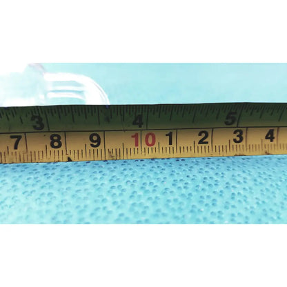 Yellow metal tape measure with black markings and red number 10 beside glass adapter for rubber tubing straight connection