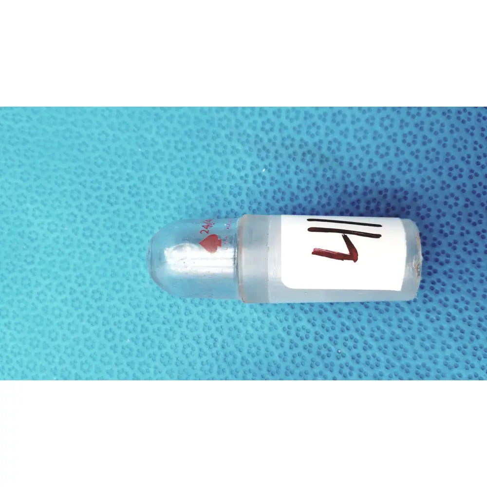 Clear plastic glass lab stopper with white 1/4 inch label and red heart symbol for ground glass lab use