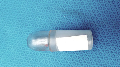 Clear plastic led light bulb with rounded dome top and white label as part of a glass flask stoppers ground glass lab set