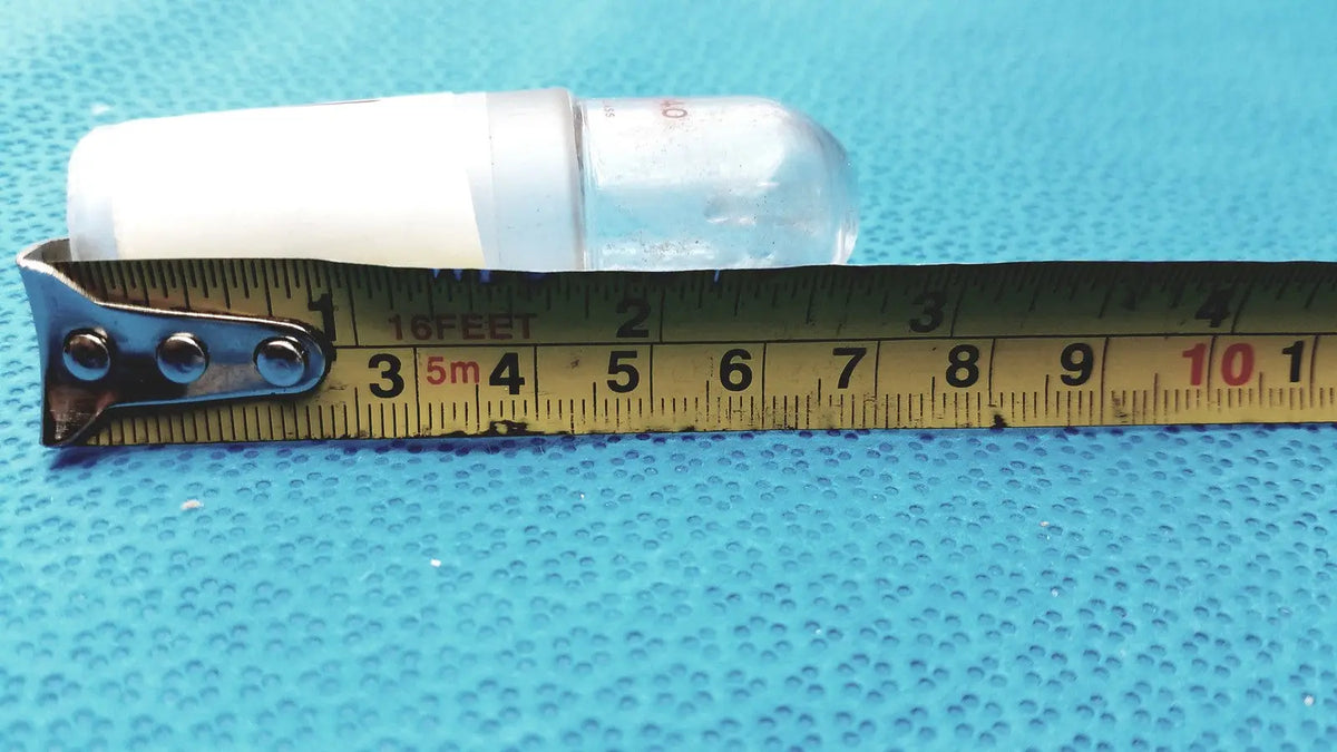 A translucent plastic ground glass lab stopper with a white cap measuring 3.5 inches for glass flask stoppers