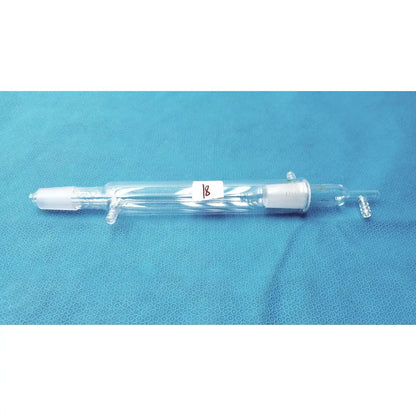Clear glass liebig condenser with white ceramic fittings and red 18 label borosilicate labware for distillation