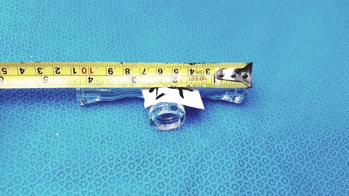 Clear glass stopcock valve adapter with white label featuring borosilicate lab control for precise flow regulation