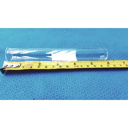 Clear glass borosilicate test tube 25x150mm with white label resting on yellow measuring tape for lab use