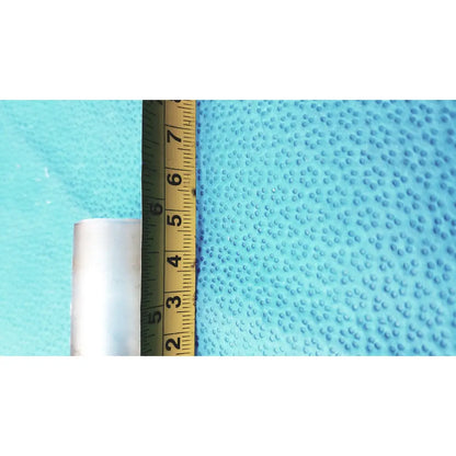 A white glass thermometer adapter with 24 40 inner joint standing beside a yellow ruler on a blue surface
