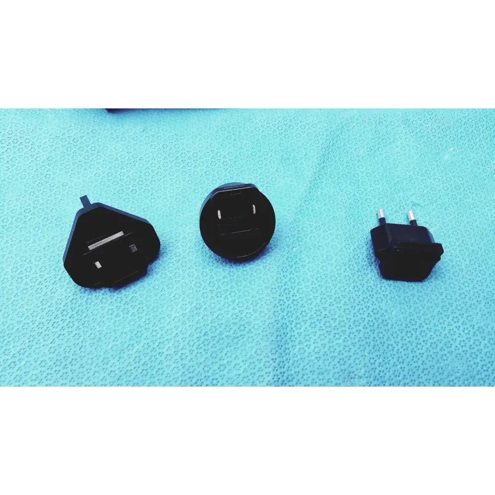 Black plastic universal travel adapter plugs in various international styles for glidescope video monitor an162878 use