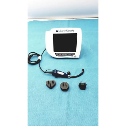 White glidescope video monitor an162878 with black screen control buttons blue-handled device and three power adapters