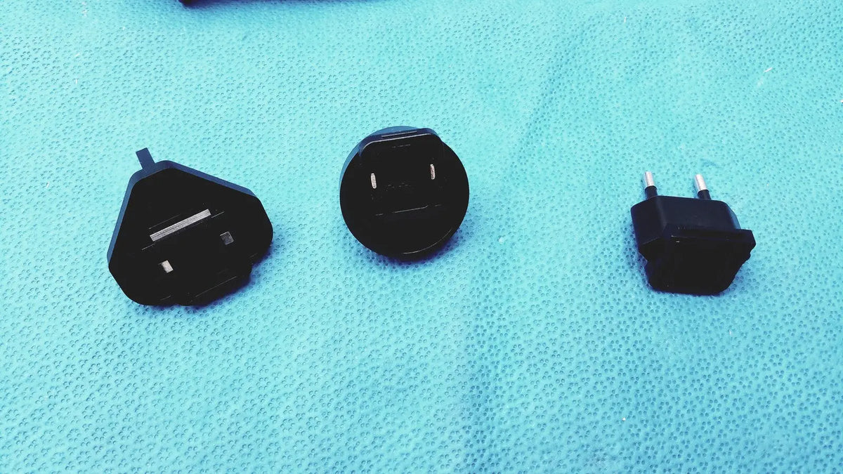Black plastic universal travel adapter plugs in various international styles for glidescope video monitor an162878 use