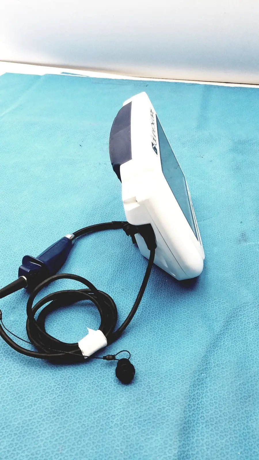 White and dark gray glidescope video monitor an162878 endoscope with coiled black cable and small microphone attached