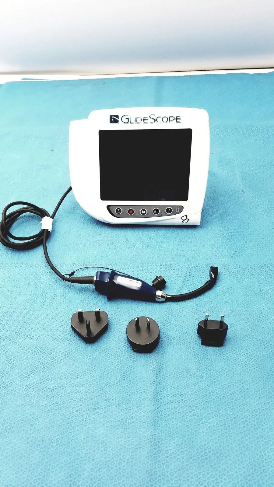 White glidescope video monitor an162878 with black screen control buttons blue-handled device and three power adapters