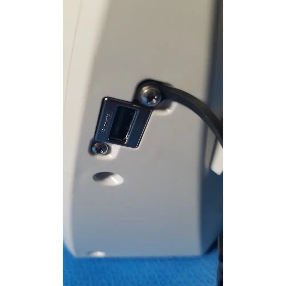 Black usb port with metallic screws on the back of a light gray glidescope video monitor device