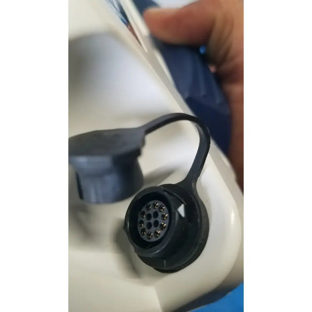 Black plastic connector with circular metal pins and loop on back side of glidescope video monitor for reuse medical use