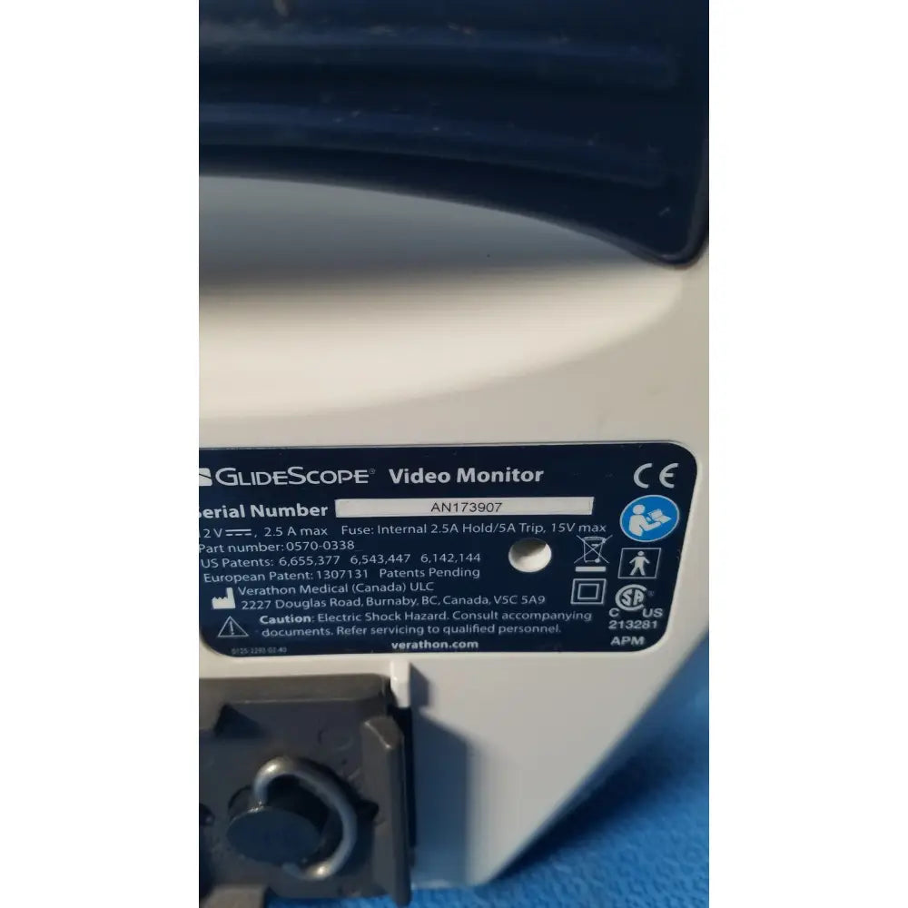 White plastic label with black text and symbols on the back of a glidescope video monitor model an173907