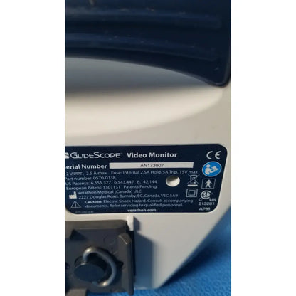 White plastic label with black text and symbols on the back of a glidescope video monitor model an173907