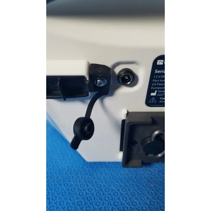 White plastic glidescope video monitor back with black rubber connectors and serial number label AN173907