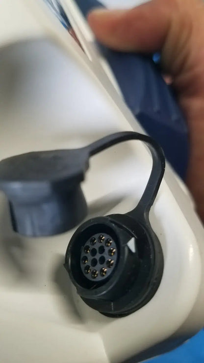 Black plastic connector with circular metal pins and loop on back side of glidescope video monitor for reuse medical use