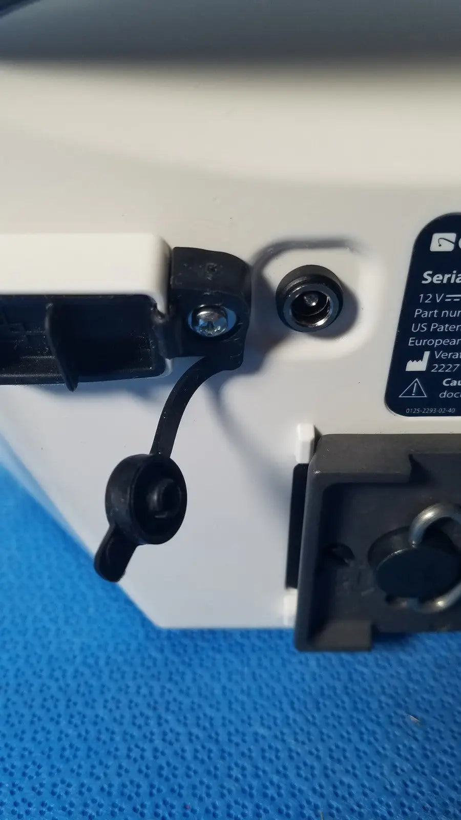 White plastic glidescope video monitor back with black rubber connectors and serial number label AN173907