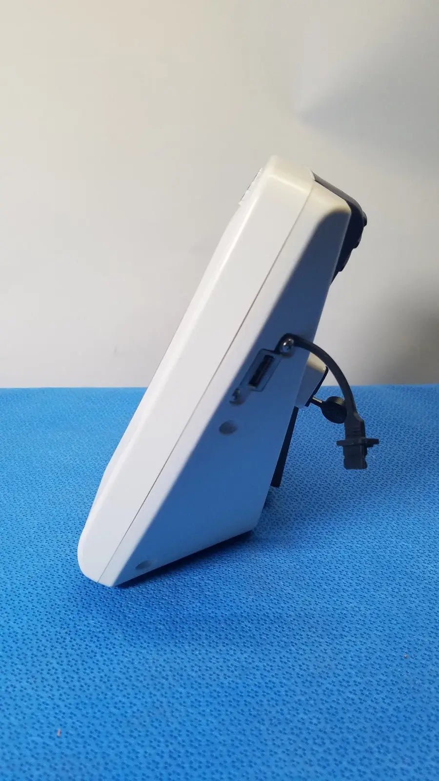 White plastic digital thermometer with black cable and connector for glidescope video monitor reuse medical applications