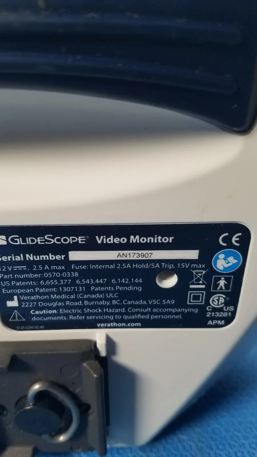 White plastic label with black text and symbols on the back of a glidescope video monitor model an173907