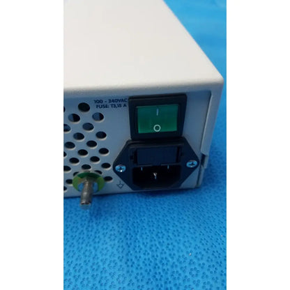 White rectangular power supply unit with green illuminated switch and black ac input port on back of globalmed jedmed xe30-eco