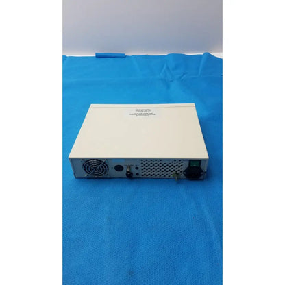 Off-white rectangular globalmed jedmed xe30-eco electronic device rear side with perforated panel ventilation fan and ports