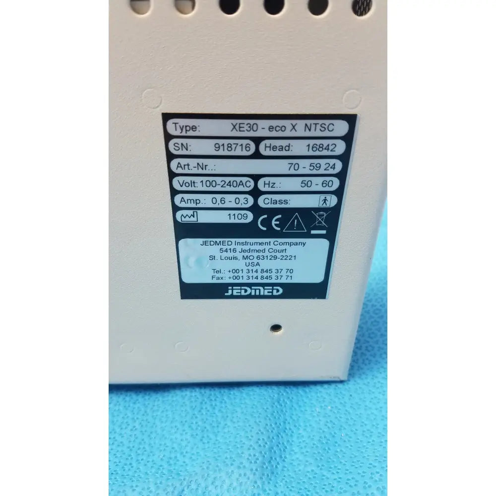 White plastic industrial power supply unit with black label for specifications of globalmed jedmed xe30-eco ntsc model