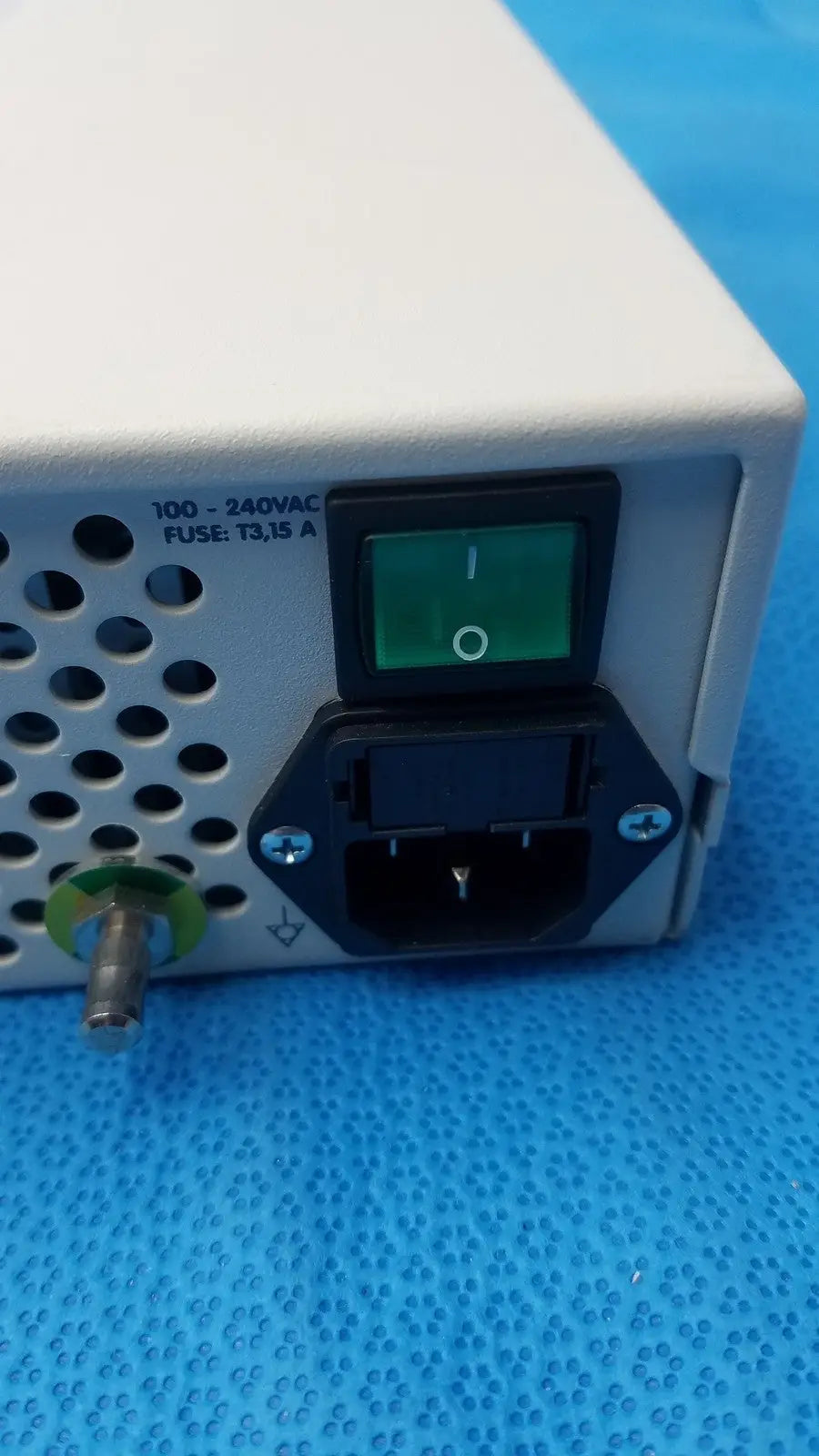 White rectangular power supply unit with green illuminated switch and black ac input port on back of globalmed jedmed xe30-eco