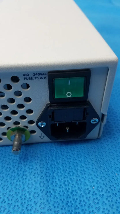 White rectangular power supply unit with green illuminated switch and black ac input port on back of globalmed jedmed xe30-eco