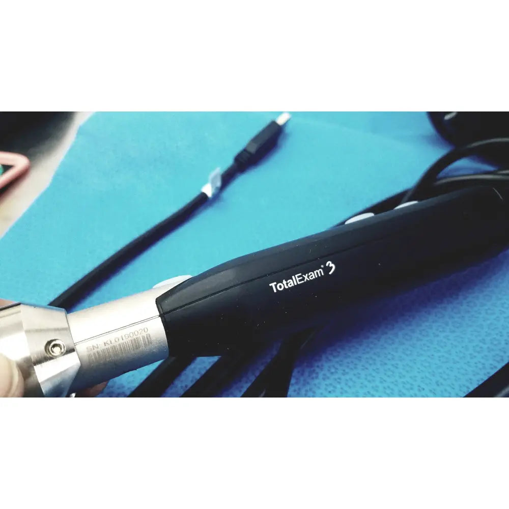 Black totalexam 3 endoscope with metallic silver connector and engraved serial number in globalmed telemedicine kit riester