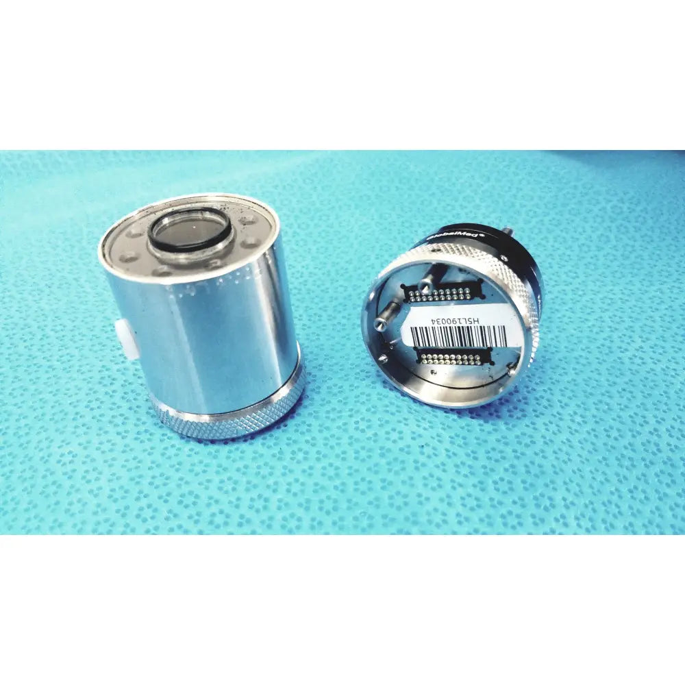 Silver cylindrical camera lens with threaded metal housing and black rubber seal in globalmed telemedicine kit riester