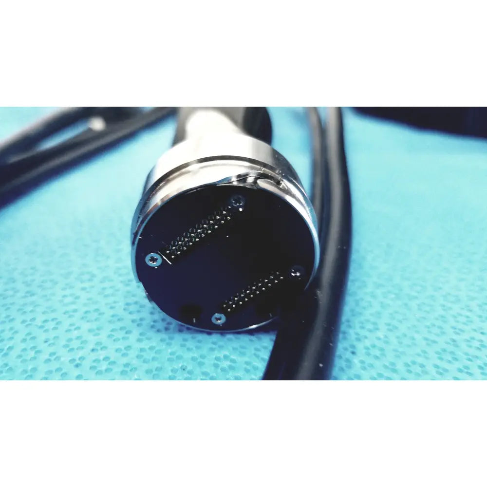 Black and silver medical-grade endoscope connector with circular metallic housing and fine pins in globalmed telemedicine kit riester