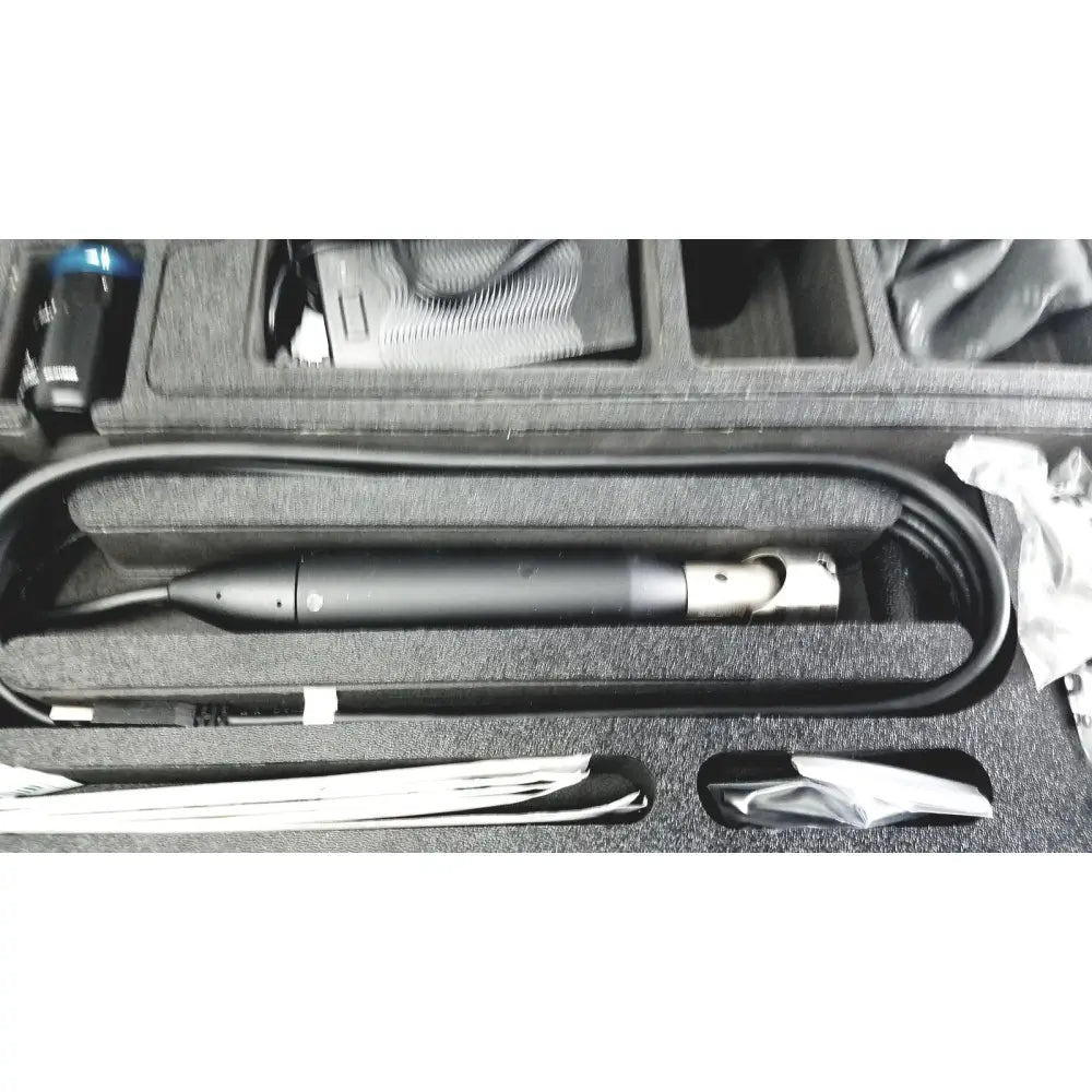 Black cylindrical endoscope with metallic joint and coiled cable in foam case from globalmed telemedicine kit riester