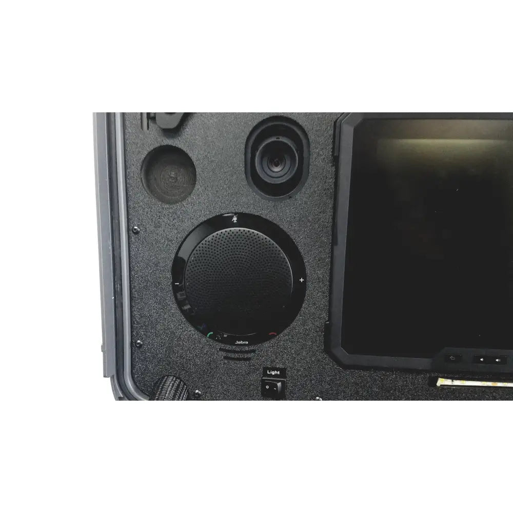 Black circular jabra speaker with perforated grille integrated into rugged case in globalmed telemedicine kit riester