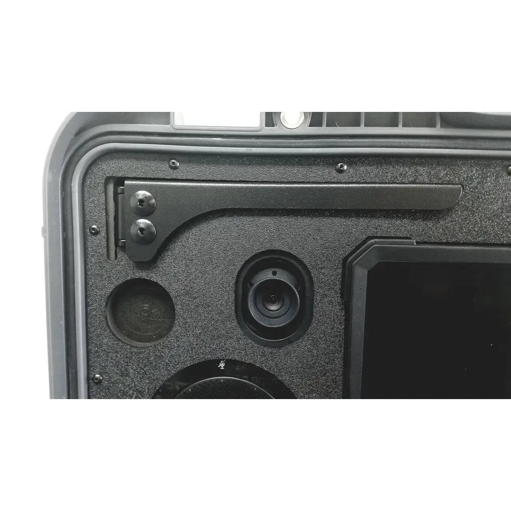 Black textured interior of rugged case with circular cutouts and mounted camera lens in globalmed telemedicine kit riester